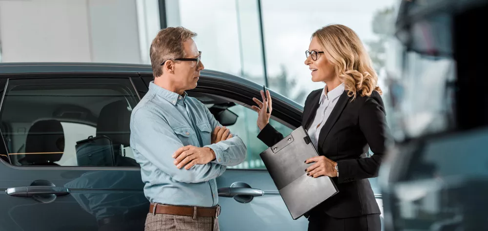 Luxury red sports car in modern showroom with bright lights and reflective floor professional automotive photography